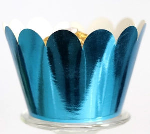 Macro detail of deep blue metallic cupcake wrapper with scalloped edges and glossy finish