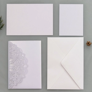 Detail view of a 4-piece laser-cut white wedding invitation suite with hollow pattern