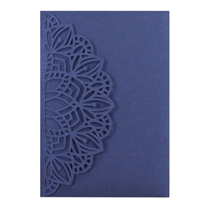 Detailed laser-cut mandala floral patterns on a dark blue pearlescent wedding invitation