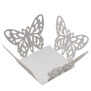 Detail of white laser-cut butterfly lace paper favor box for wedding and party decoration