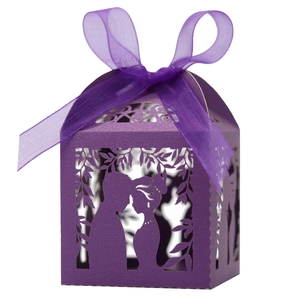 Purple laser-cut wedding favor box with ribbon featuring a romantic silhouette scene