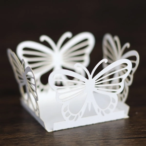 Detailed laser-cut white butterfly lace wrapper for wedding candy and party cupcakes