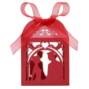 Detailed laser-cut wedding favor box in red with couple silhouette and organza bow