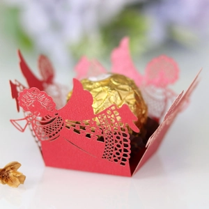 Detail of red laser-cut angel chocolate holder with gold foil truffle for party