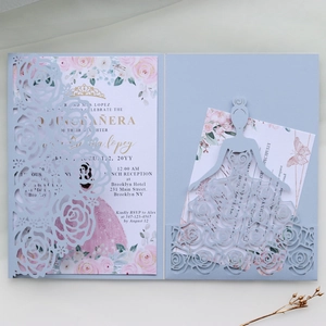 Detail of laser-cut rose hollow invitation card with watercolor pink floral inner sheet