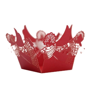 Detail of red laser-cut paper cupcake wrappers featuring delicate angel designs