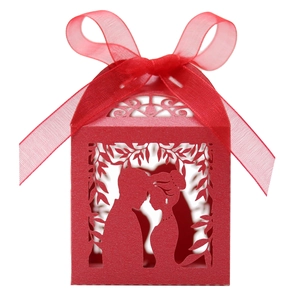 Laser-cut red wedding favor box with romantic couple silhouette and red ribbon bow