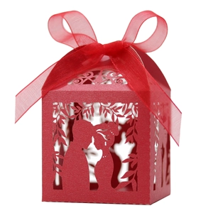 Red laser-cut wedding favor box featuring bride and groom silhouette and ribbon bow