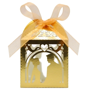 Detail of laser-cut wedding candy box with bride and groom silhouette and ribbon bow