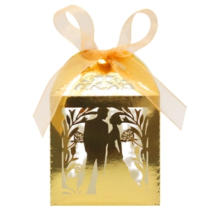 Detail of laser-cut gold wedding favor box featuring romantic couple silhouette and ribbon