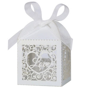 Detail of laser-cut heart pattern and Love lettering on white pearlescent paper gift box