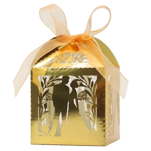 Golden laser-cut wedding favor box with romantic couple silhouette and orange ribbon