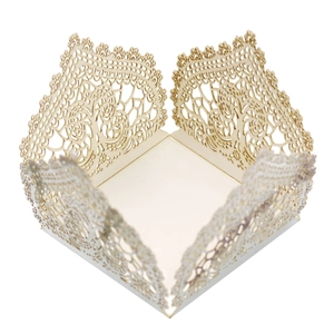 Detailed laser cut lace pattern on cream wedding candy box with elegant scalloped edges
