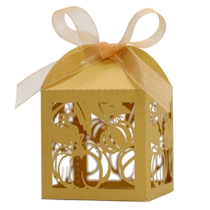 Golden laser-cut pumpkin favor box with orange ribbon for Thanksgiving and parties