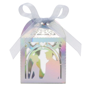 Detail of laser-cut iridescent wedding favor box with bride and groom silhouette