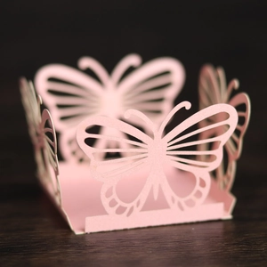 Detailed laser-cut butterfly paper gift box with intricate hollow design in soft pink