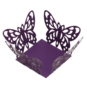 Close-up of laser-cut purple butterfly paper candy box with intricate hollow lace details