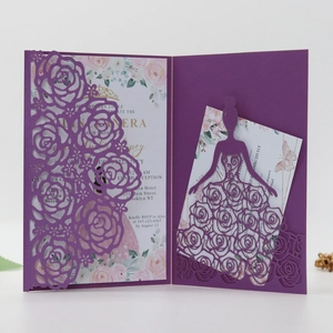 Detail view of laser-cut purple rose floral wedding invitation with intricate lace patterns