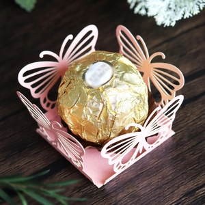 Laser-cut pink butterfly candy holder for wedding favors with a hollow design detail