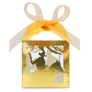 Detailed laser-cut cowboy silhouette on golden gift box with elegant yellow ribbon