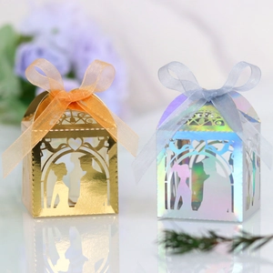 Detail of laser-cut wedding favor boxes in gold foil and holographic laser paper