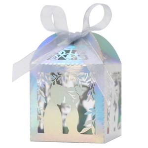 Detail of laser-cut iridescent wedding favor box with romantic couple silhouette
