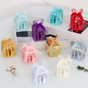 Detail of laser-cut wedding favor boxes with ribbon bows in various macaron colors