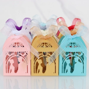 Macro view of laser-cut hollow silhouette gift boxes with organza bows in various colors
