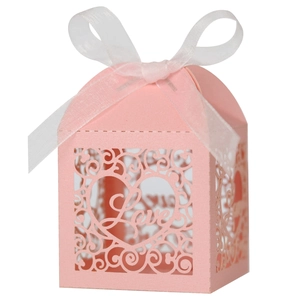 Detailed laser-cut pink gift box with heart patterns and a white organza ribbon bow