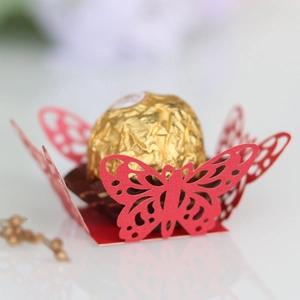 Macro shot of laser-cut red butterfly chocolate holder with intricate hollow patterns