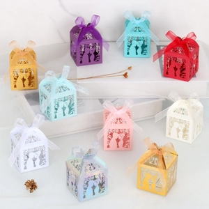 Macro view of laser-cut wedding favor boxes with ribbon bows in ten vibrant colors