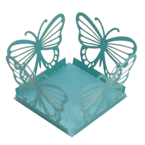 Detail of laser-cut butterfly cupcake wrapper made of light blue textured cardstock