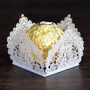 White laser-cut lace candy box for wedding party with intricate floral hollow design