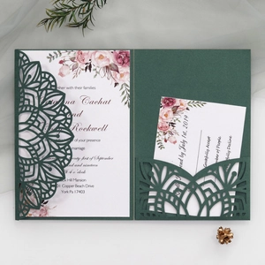Elegant emerald green laser-cut wedding invitation set with floral inner cards and envelopes