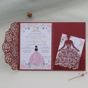Detail of laser cut dark red rose lace invitation card with elegant gold crown design