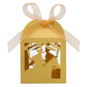 Detail of laser-cut gold candy box with horse rider silhouette and satin ribbon