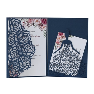 Detail of laser-cut navy wedding invitation with floral insert and bride silhouette