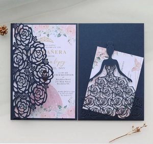 Detail of navy blue laser cut invitation card featuring delicate rose patterns and white insert