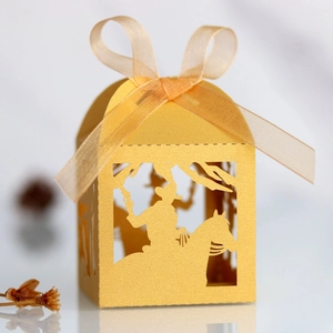 Detailed laser-cut cowboy horse candy box in golden yellow paper with ribbon bow