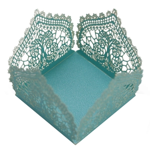 Macro detail of laser-cut light blue candy box with intricate floral lace texture