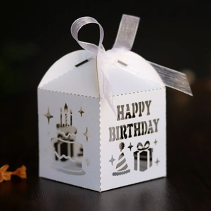 Detail of laser-cut 'HAPPY BIRTHDAY' candy box with elegant white organza ribbon