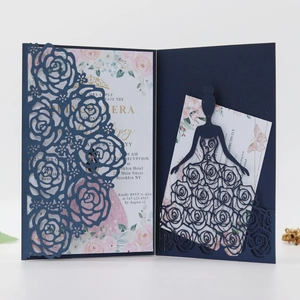 Detail of laser-cut navy blue wedding invitation set with elegant rose pattern