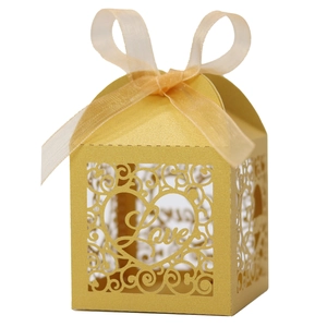 Macro view of laser-cut Love pearl paper candy box with ribbon and heart detail