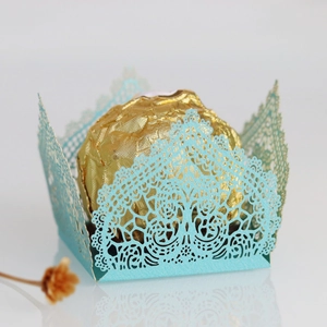 Macro view of laser-cut light blue lace paper wrapper for luxury chocolates