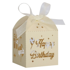 Detail of laser-cut Happy Birthday candy box with balloon patterns and white ribbon bow