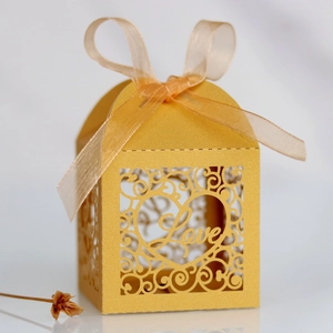 Laser-cut hollow gold favor box with Love heart pattern and silky ribbon tie