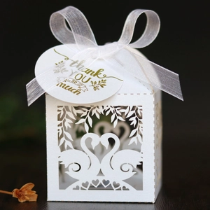 White laser cut wedding favor box with swan heart design and thank you tag ribbon