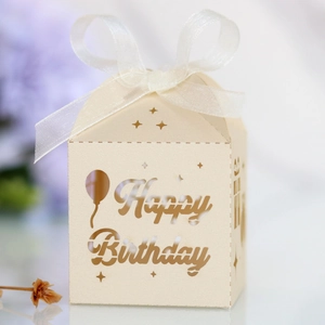 Detail of laser-cut Happy Birthday candy box with ivory finish and white ribbon bow