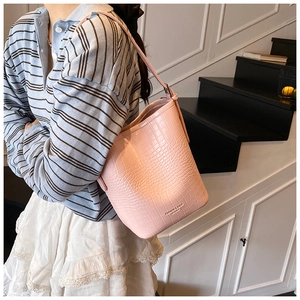 Detail of pink bucket bag with crocodile texture and Fashion & Bags Leather text
