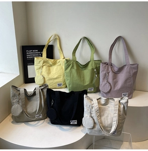 Multiple colors of large capacity nylon tote bags with matching round coin purses